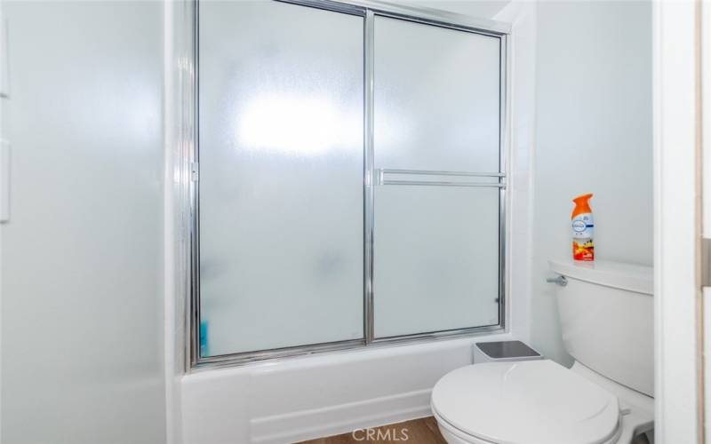 Another view of hall full bathroom; shower over tub.