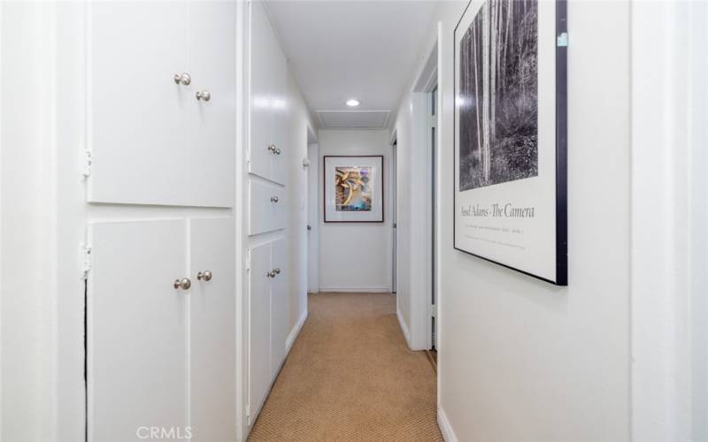 End of hallway; turn to the left to enter th spacious Primary Suite with view of the pool and grounds.