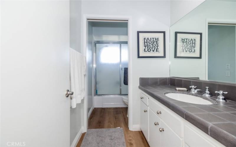 Hall full bathroom with shower over tub. This bathroom services Bedroom #1 and Bedroom #2