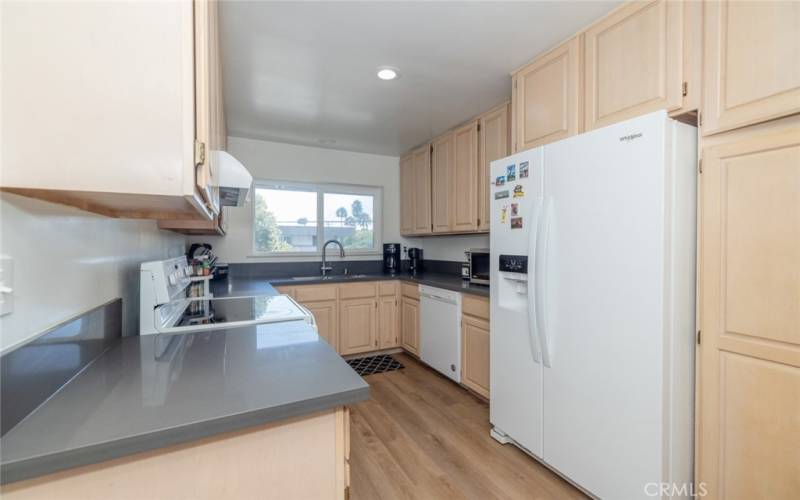 Galley type kitchen; appliances included: Refrigerator, Microwave, freestanding electric range and oven. dishwasher, garbage disposal. vented hood