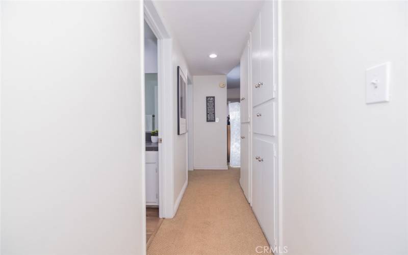 Hallway to Bedroom #1, full bathroom which services Bedroom #1 and Bedroom #2. Notice there is plenty of storage.