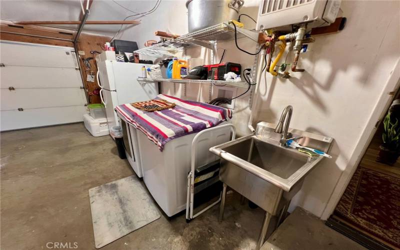 Laundry in garage with utility sink.