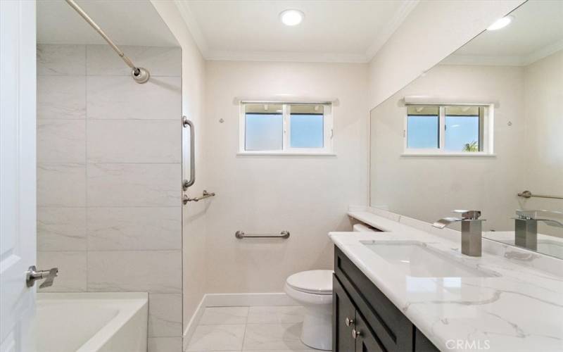 Hallway Bathroom with Tub Shower Combo, Quartz Countertops, Designer Faucet