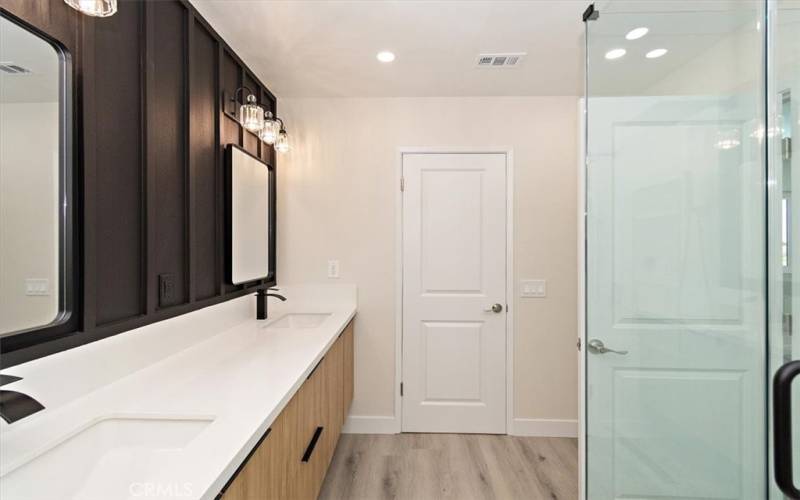 Primary Bath has Double Sinks, Floating Cabinet with Quartz Countertops, Designer Light Fixtures,