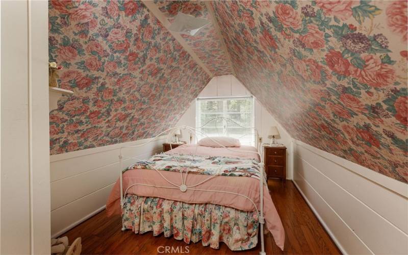 The 'pink bedroom' with hardwood floor.