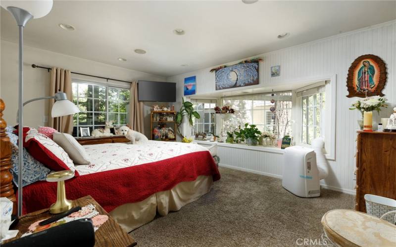 Spacious apartment bedroom with window seat.