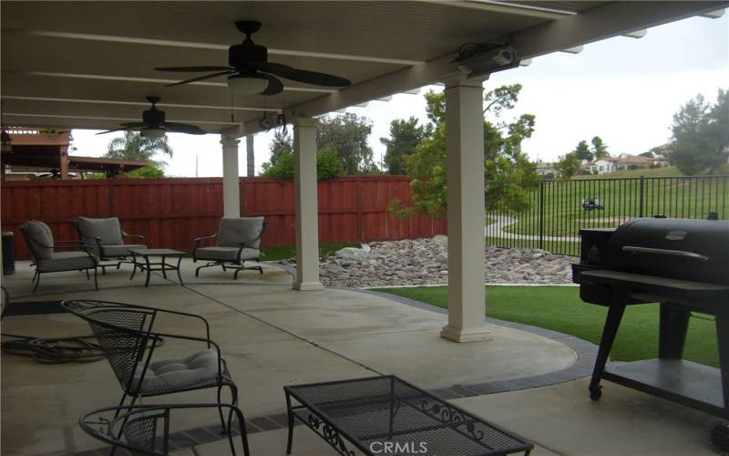 Exterior Back Yard. Covered Patio with 2 Ceiling Fans. Artificial Grass