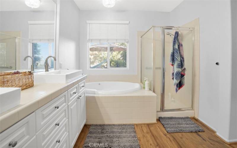 Master Bathroom with double sinks, soaker tub, and separate shower