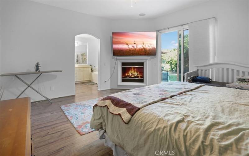 Master Bedroom with fireplace and looking into Master Bathroom