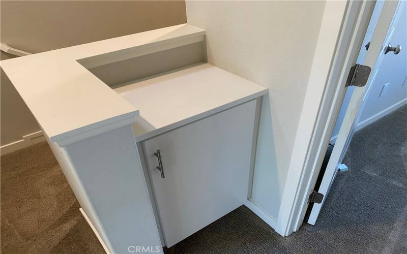 Linen storage at the top of the stairs leading to the bedrooms.
