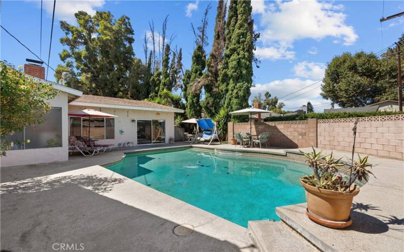 Private backyard with patio and sparkling pool.