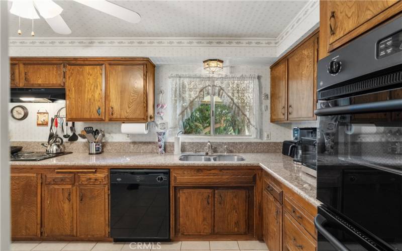 A spacious eat-in kitchen with granite counter tops and a large breakfast nook.