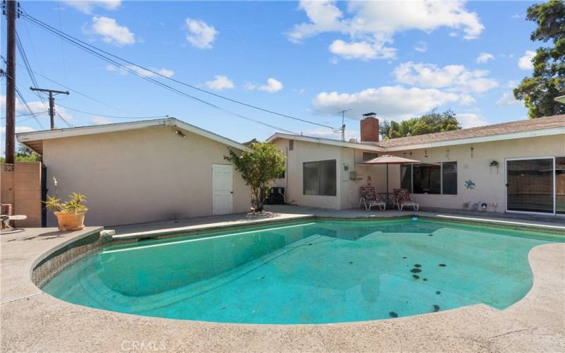 Private backyard with patio and sparkling pool.