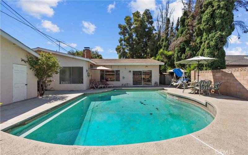 Private backyard with sparkling pool and patio.