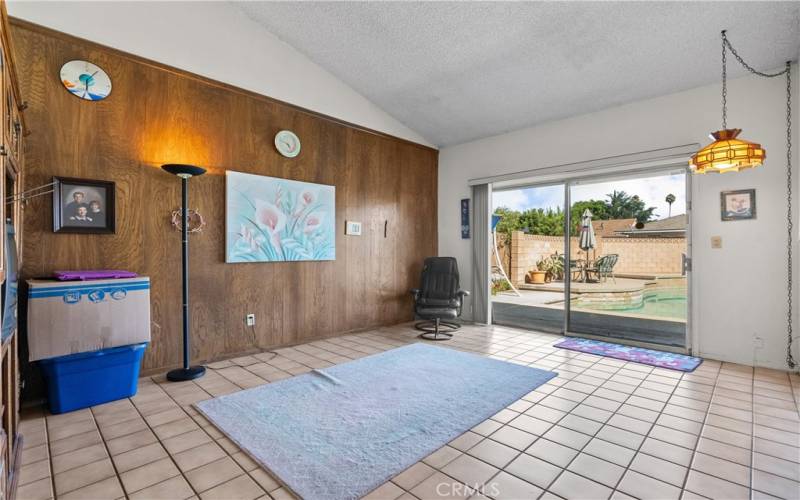 Step down Family Room with vaulted ceilings and sliding door to the backyard patio and sparkling pool.