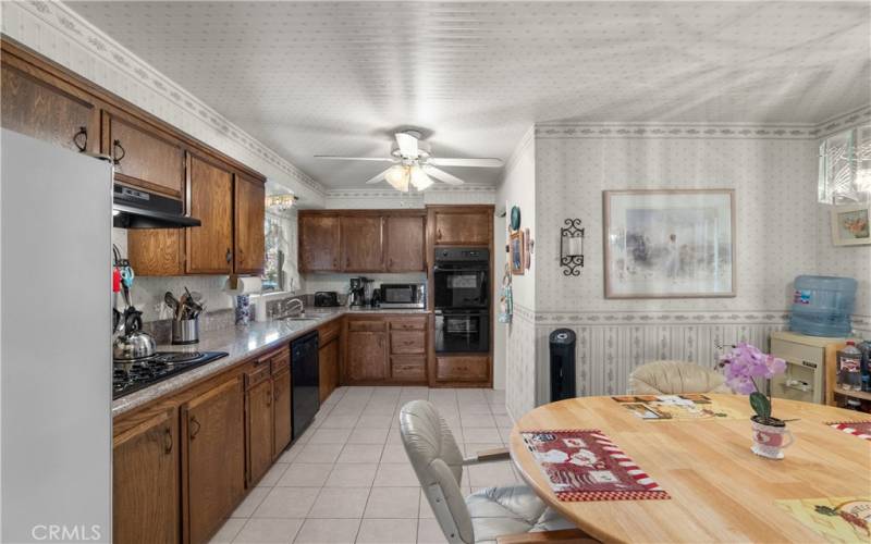 A spacious eat-in kitchen with granite counter tops and a large breakfast nook.