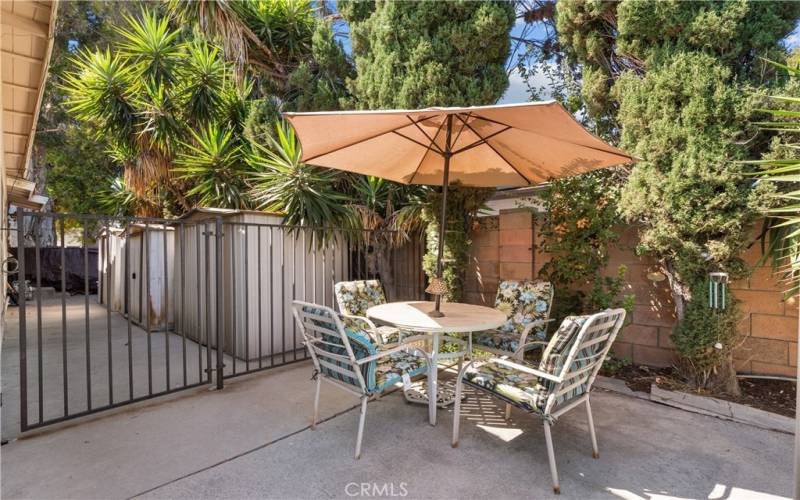 Private backyard with patio and sparkling pool.