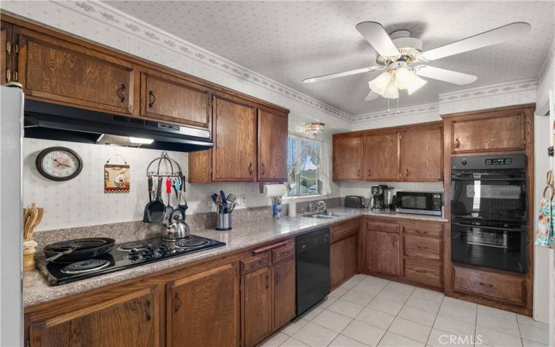 A spacious eat-in kitchen with granite counter tops and a large breakfast nook.