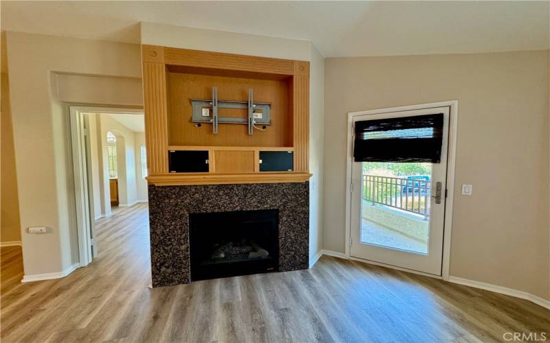 Fireplace and doors to main bedroom and balcony