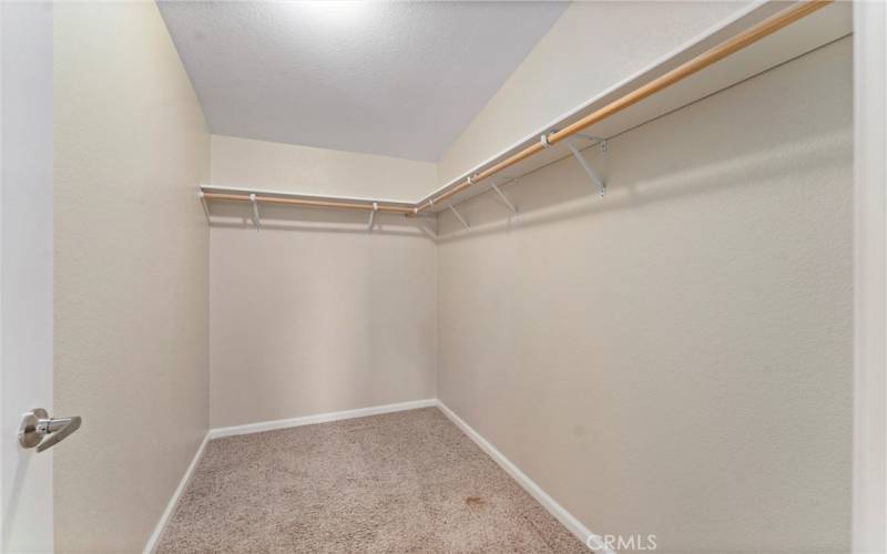 Primary bedroom walk in closet