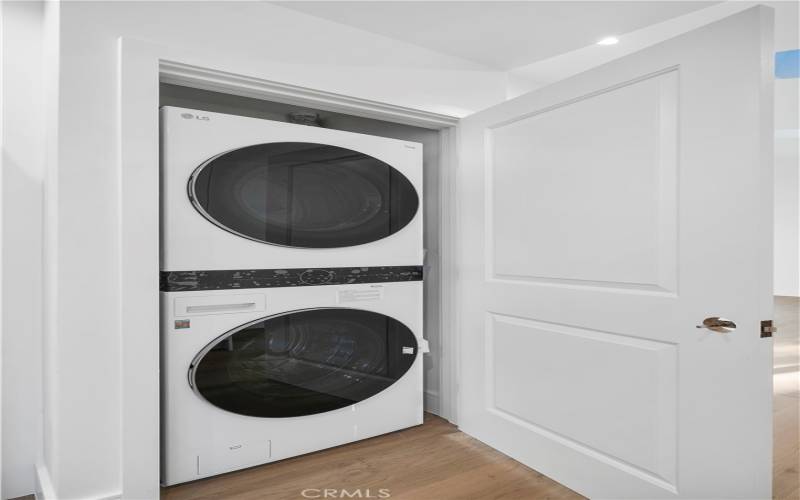 Washer dryer included and installed in a closet next to the kitchen.