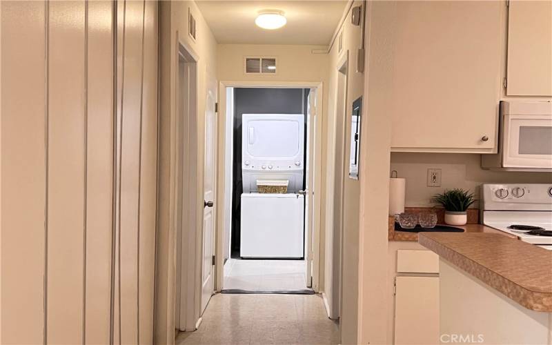 Hallway with cabinets and storage