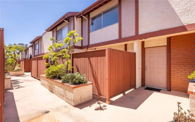 Front door of unit nestled in the back of the complex