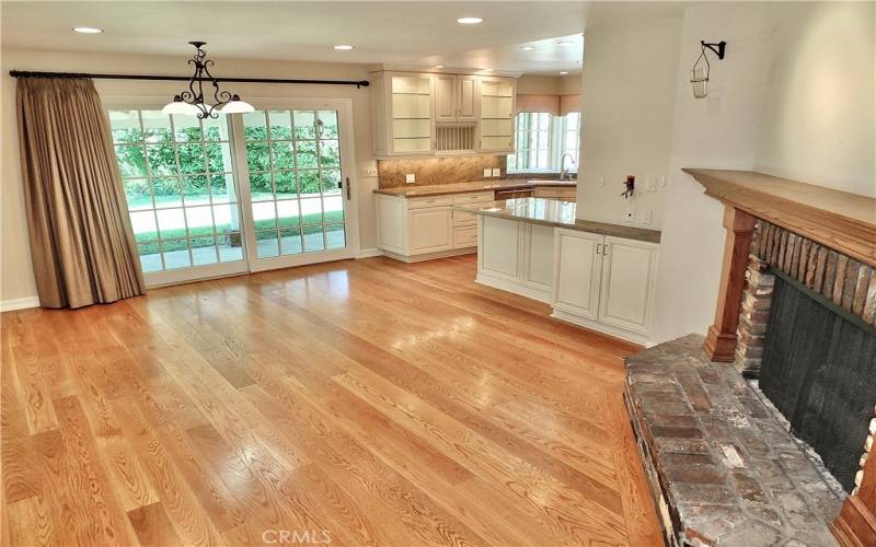 family/dining room overlooking the warm romantic brick gas fireplace