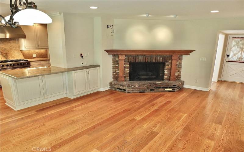 family/dining room overlooking the warm romantic brick gas fireplace and open to the remodeled kitchen