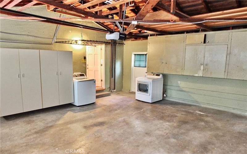 attached two car garage with direct house access, ample storage, and a washer/dryer