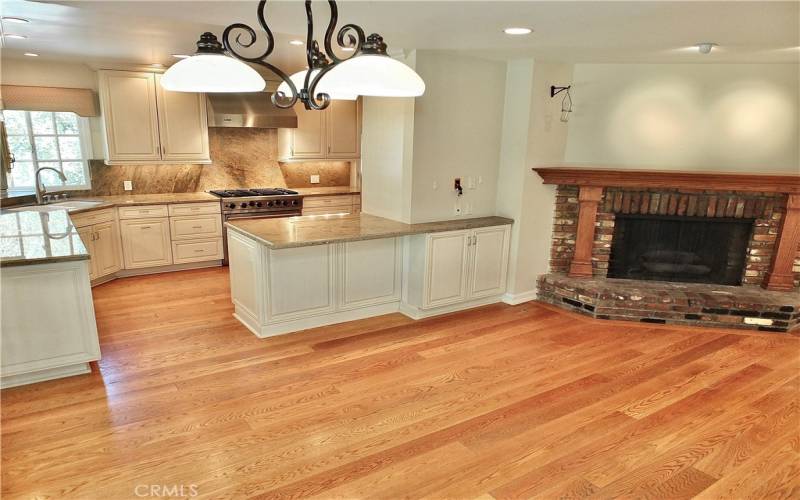 family/dining room overlooking the warm romantic brick gas fireplace and open to the remodeled kitchen