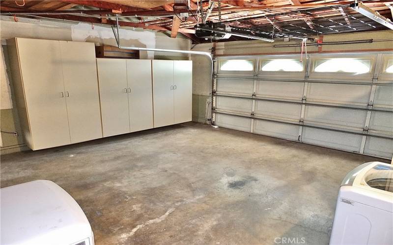 attached two car garage with direct house access, ample storage, and a washer/dryer