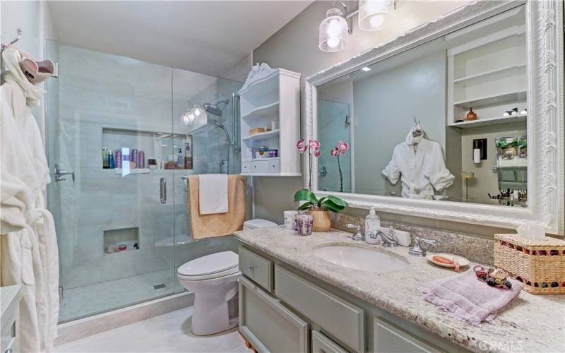 Primary bathroom with remodeled shower.