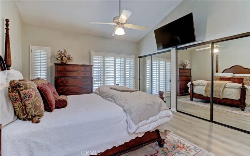 Primary bedroom with mirrored wardrobe doors.