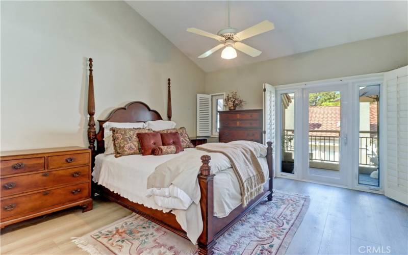 Primary bedroom with french door to the balcony.