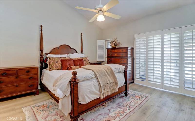 Primary bedroom with vaulted ceiling.