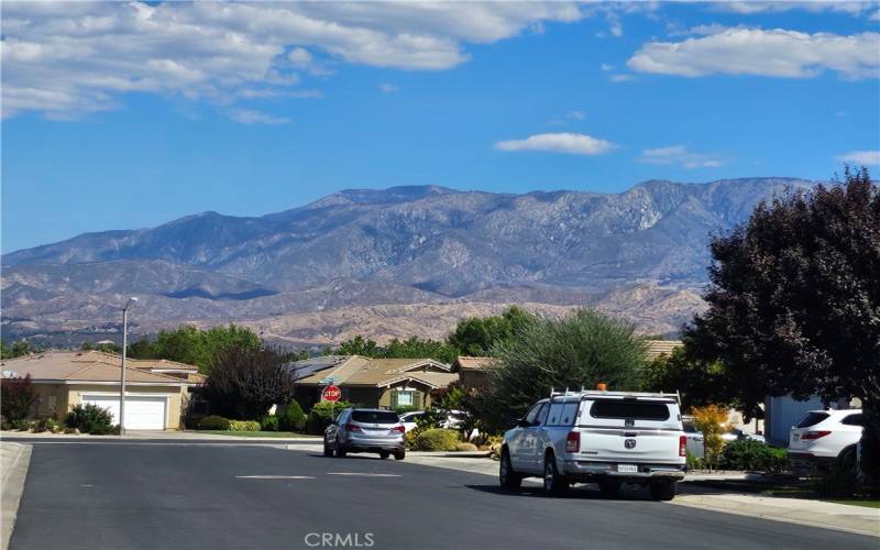 FRONT OF HOME SEES MOUNTAIN BACKDROP