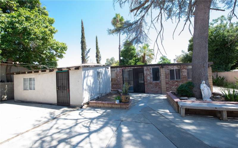 The laundry and utility rooms are in the white building which is attached to the ADU.