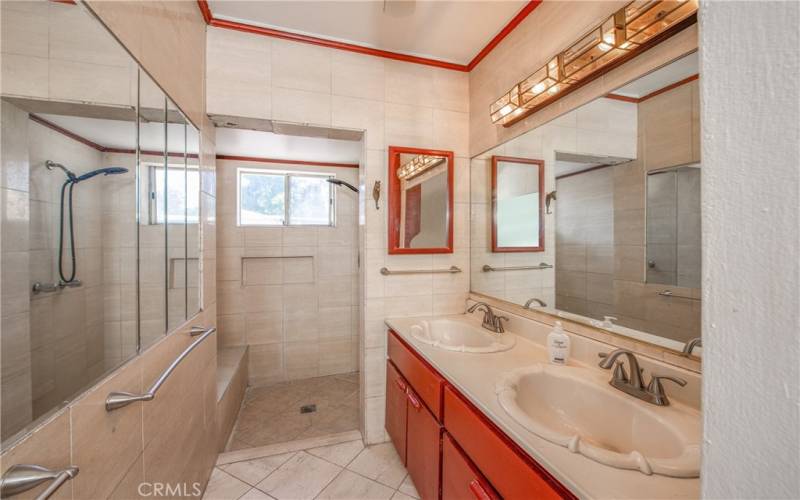 The hall bath has dual sinks and a tiled walk in shower.