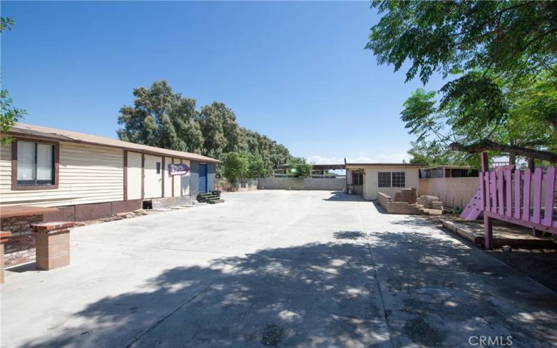 The long concrete driveway continues to the end of the property.