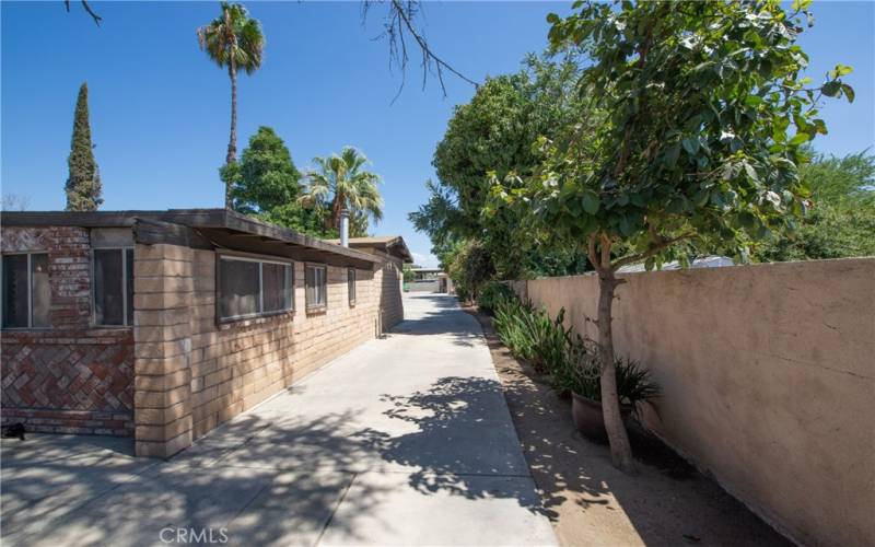 The long concrete driveway goes to the end of the property.