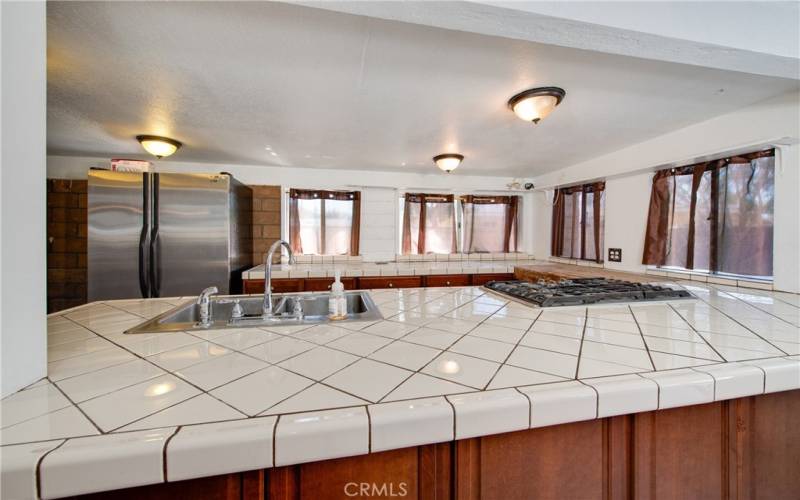 The kitchen in the ADU has a large countertop, a gas stovetop and a NEW sink and NEW fixtures.