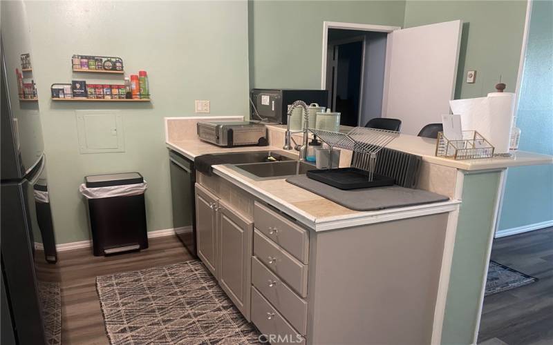 Kitchen with dishwasher and stainless steel sink