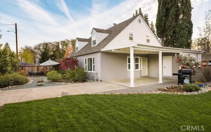 View of the carport, side yard and backyard area.  The backyard is fully fenced with a gate to the carport area.