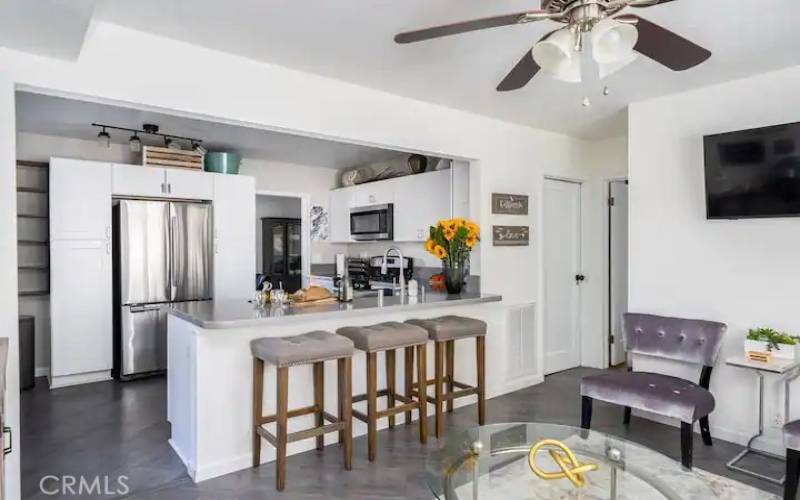 View of kitchen with eating bar, lots of cabinets.