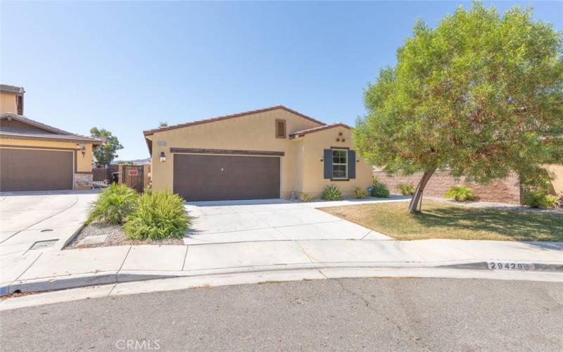 This well-maintained home features charming curb appeal with its mature trees and large driveway