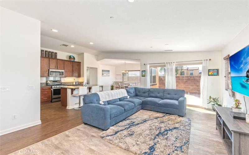 This inviting open-concept living space features a modern kitchen, and ample natural light, creating a bright and welcoming atmosphere.