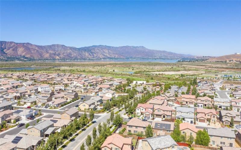 This vibrant community offers stunning views of the nearby lake, surrounded by majestic mountains, creating a picturesque and serene living environment.