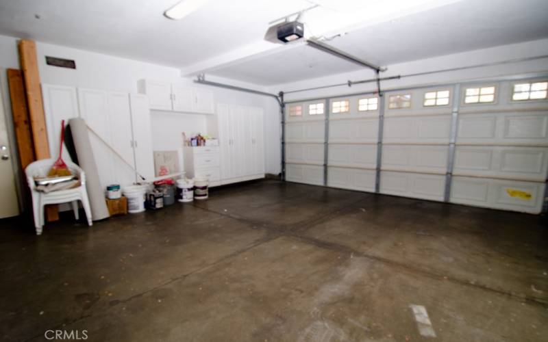 2 car garage with storage and access to side patio