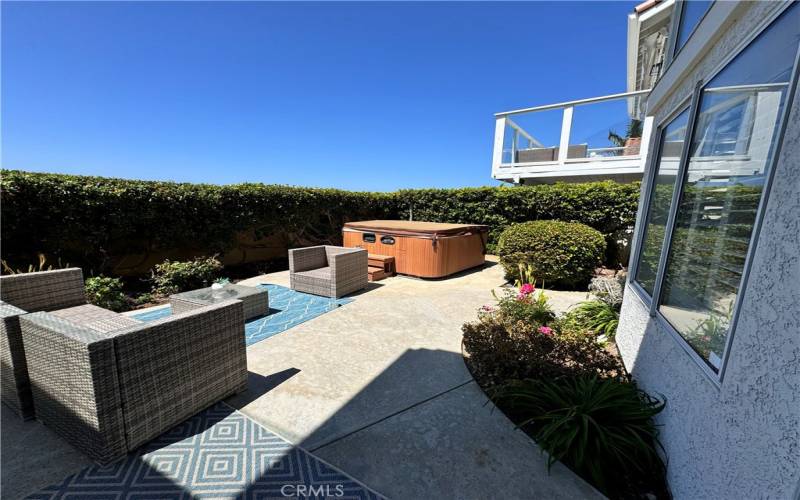 Back yard/patio area with outdoor furniture and hot tub